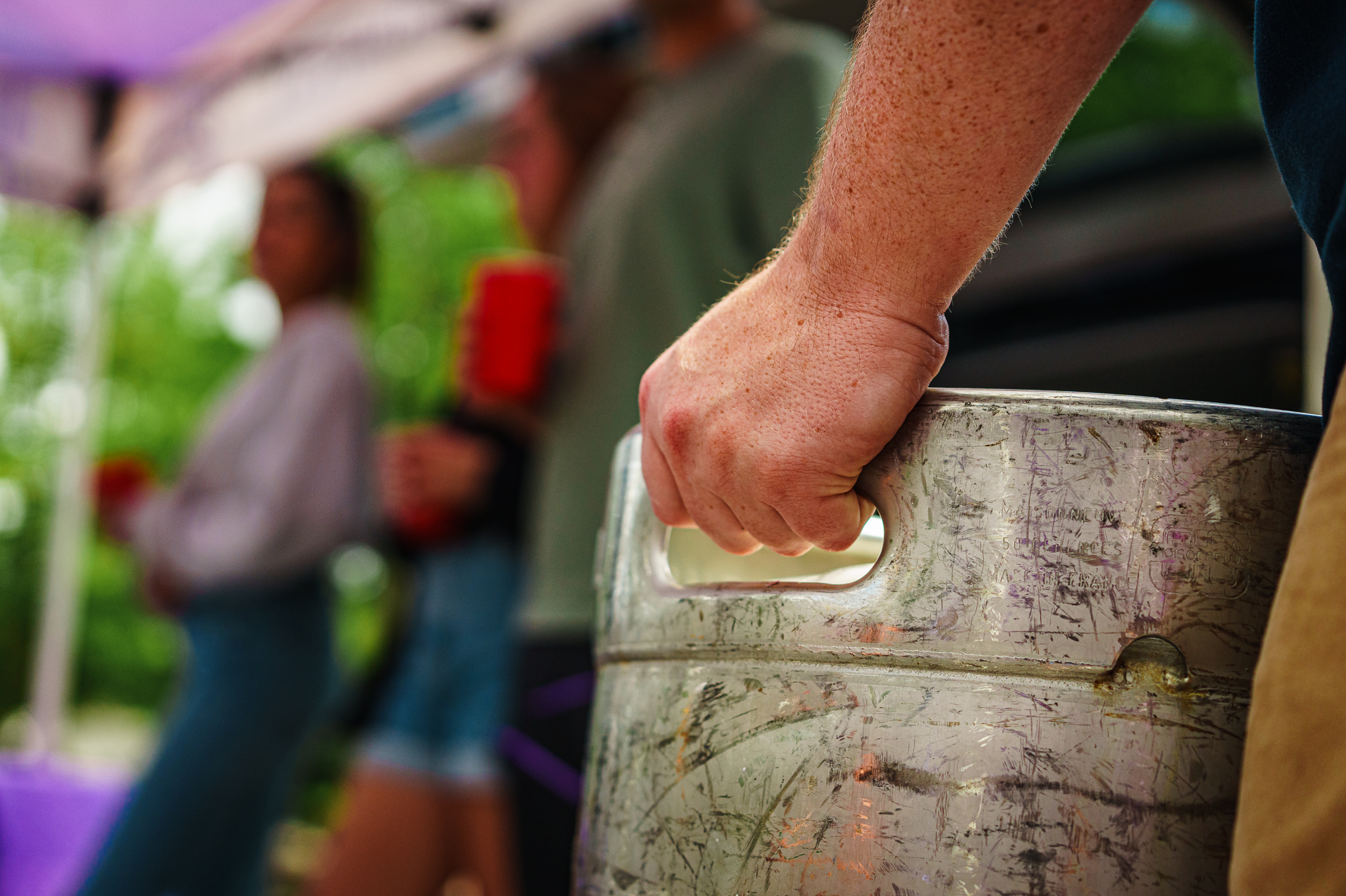 carrying a keg of abita beer to a football tailgate