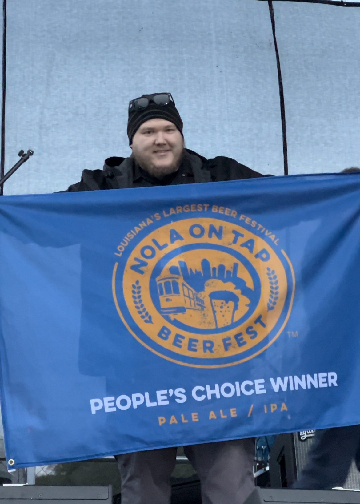 brewery kyle with winning flag at the Nola on Tap beer fest