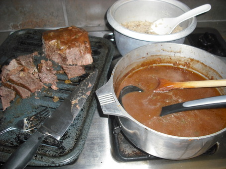 Finished roast resting next to pot of gravy