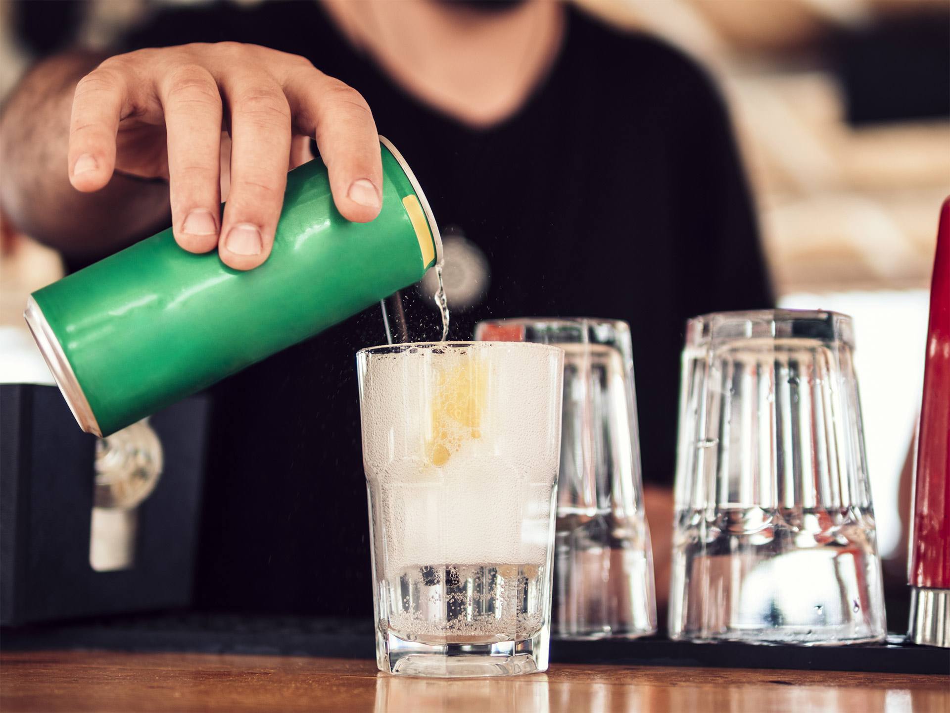 hand pouring a spirit based ready to drink private label cocktail into a glass