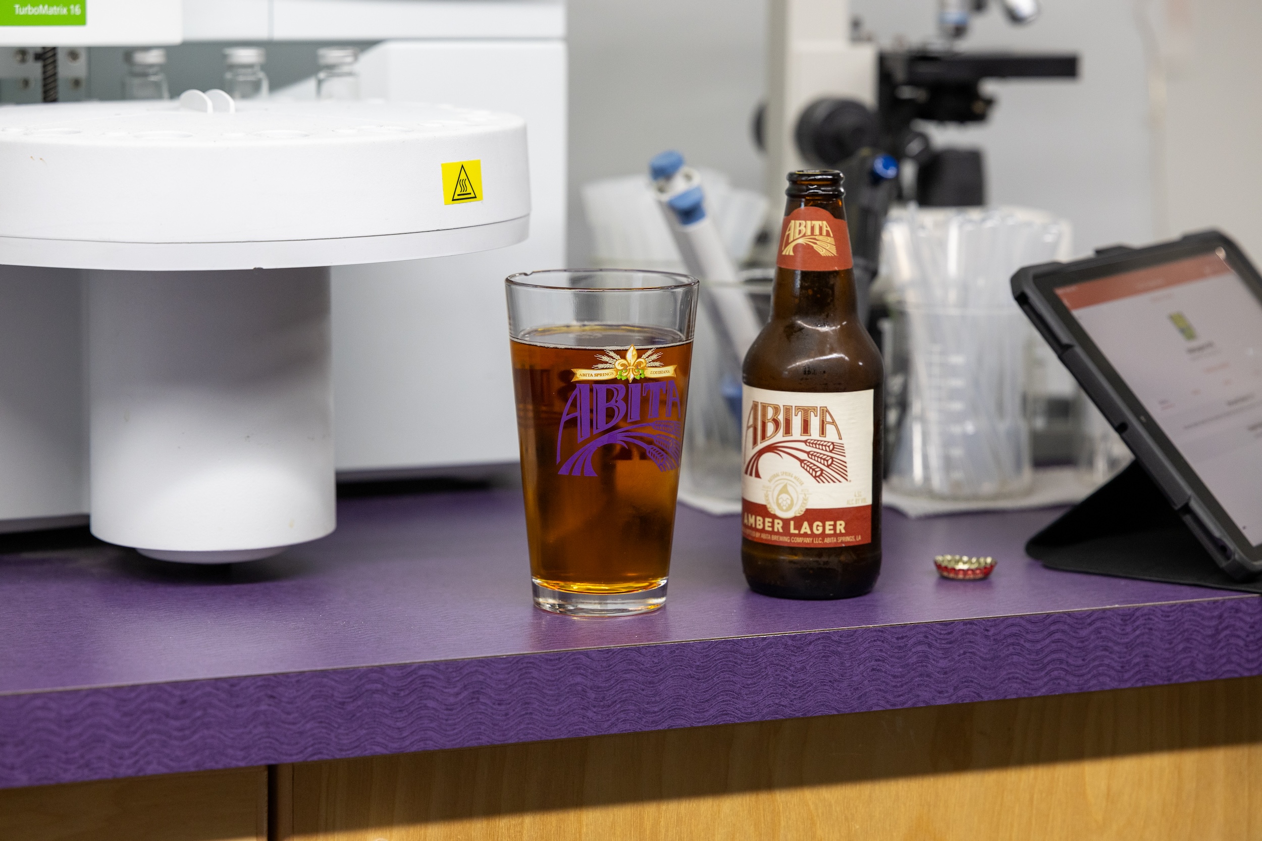 bottle of Abita beer poured into a glass exemplifying the positive drinking experience of having a bottled beer vs canned