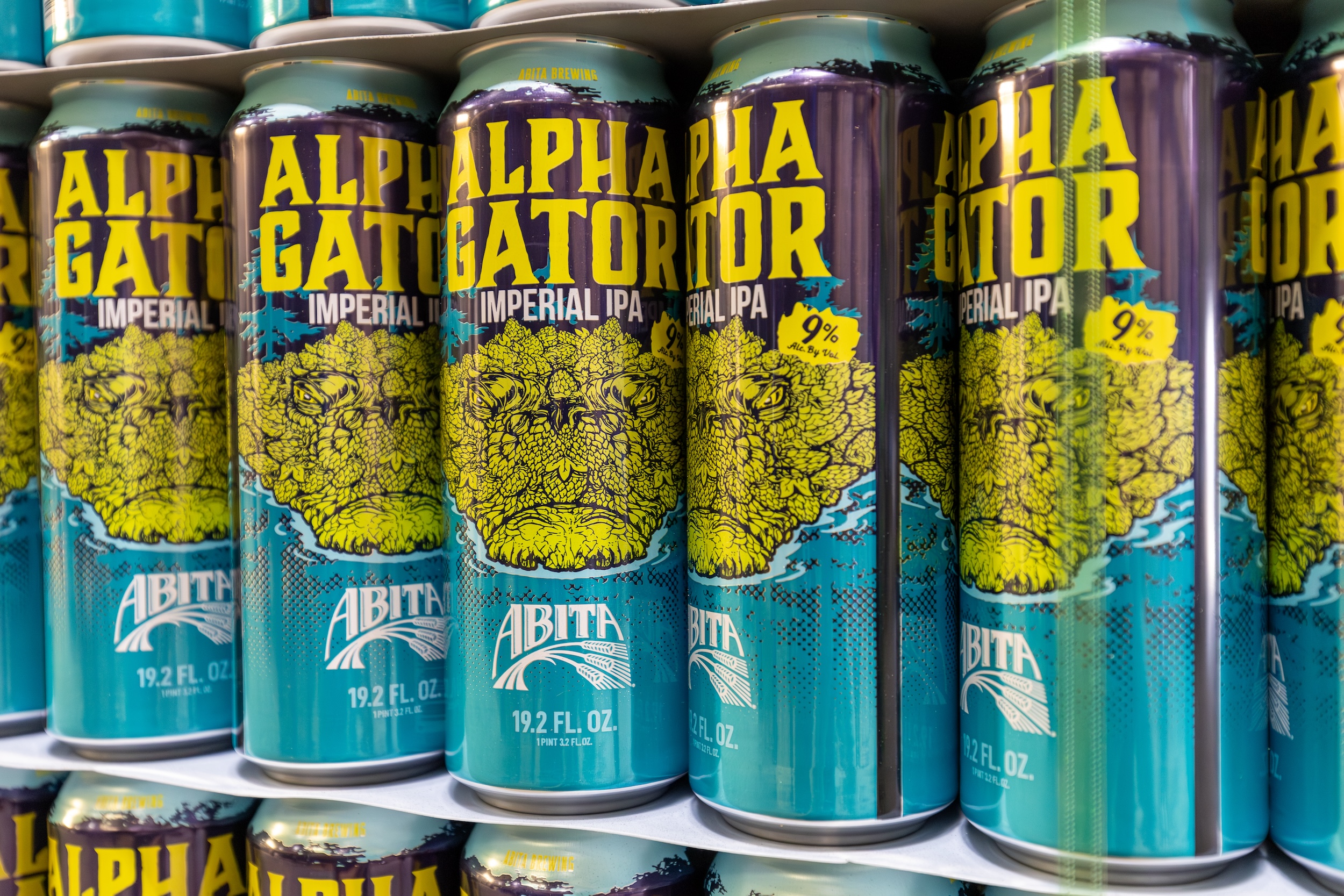 cans of Abita Alphagator beer stacked in an open brewery production facility