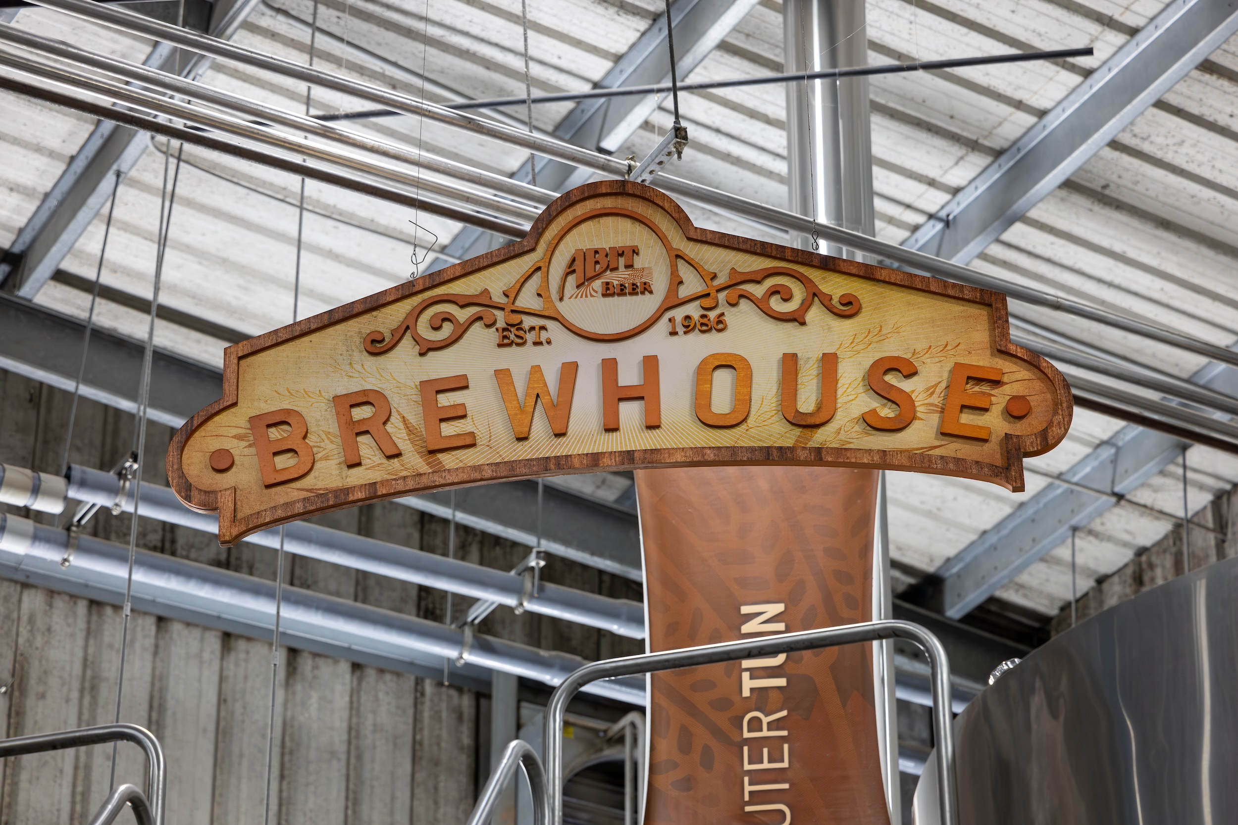 Abita brewhouse sign hanging from the ceiling of their open brewery manufacturing facility