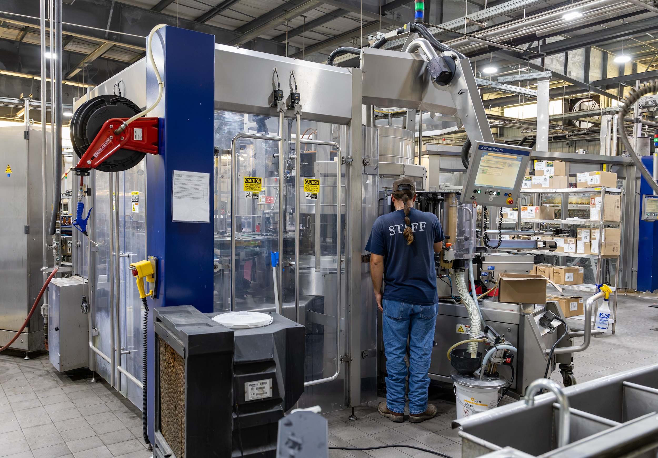 man handling equipment in an open brewery facility