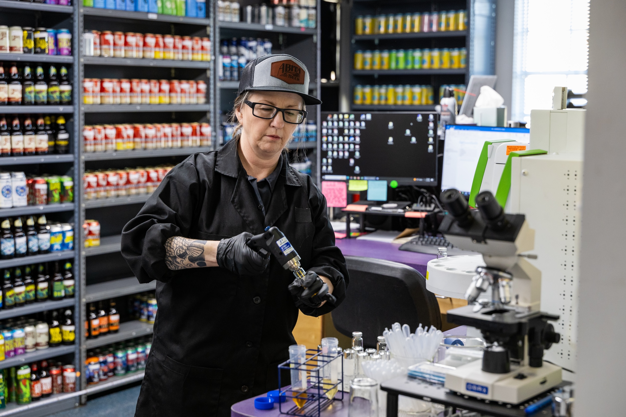 woman in a lab showing how to start a brewery by initiating quality control measures